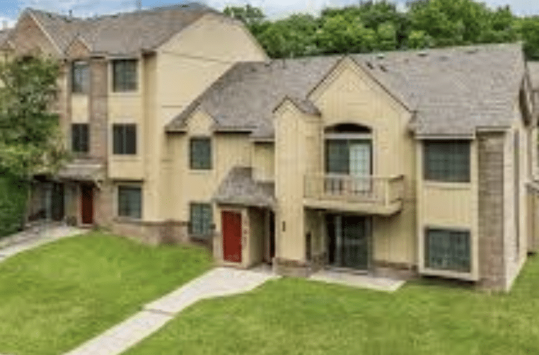 Exterior of upscale townhomes with stone and stucco finishes.