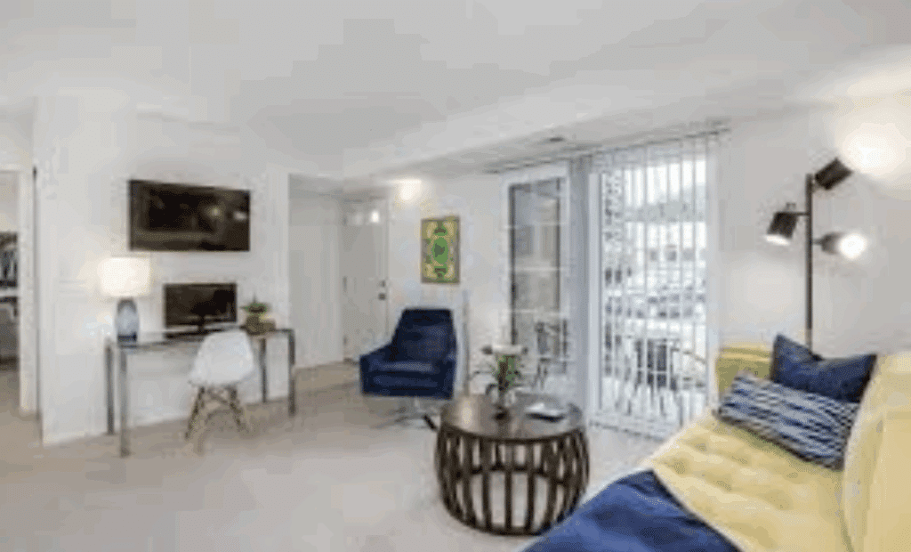 Bright apartment living room with large windows.